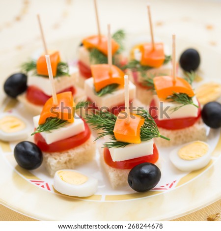 Cold snacks. Canapes of feta cheese and vegetables