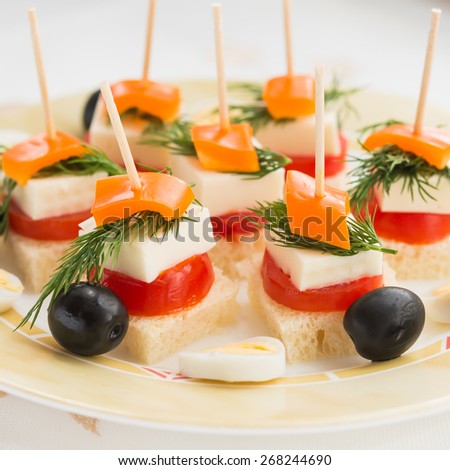 Cold snacks. Canapes of feta cheese and vegetables