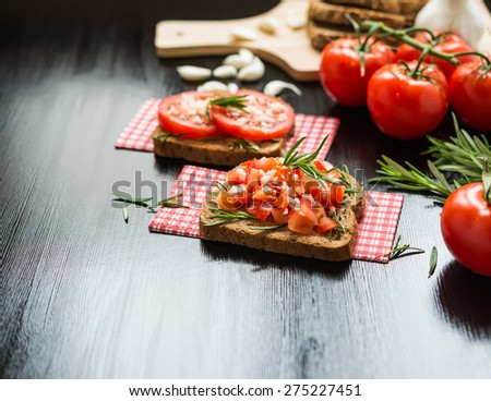 Healthy Foods. Vegetarian food. Sandwiches with vegetables. Italian Bruschetta. Bread with chopped tomatoes, garlic, rosemary.