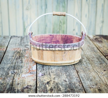 Empty old wooden basket on wooden table. Vintage background.