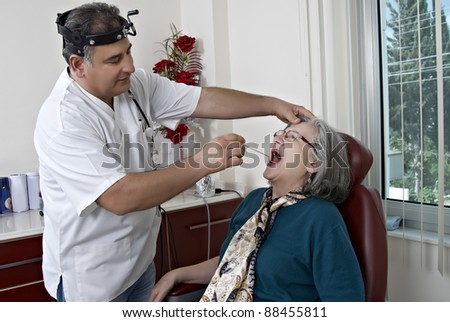 Doctor exam mature patient ear