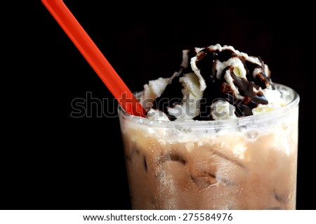 Float vanilla Sundae ice cream on dark mocha smoothie with red straw with black background