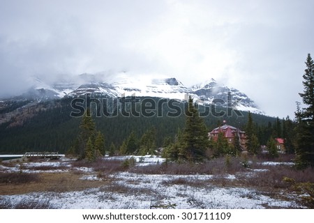 little lodge near snow mountain in Canada