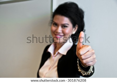 Business woman smile and give thumb up on white background