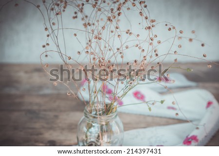 Stilllife with Dry Flowers and Scarf with Red Flowers on Wooden Background