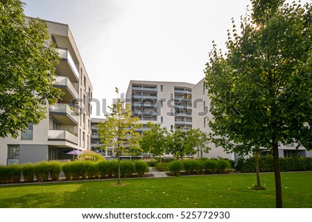 Apartment buildings in the city - Facades of new modern residential houses in green environment