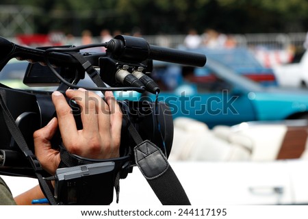 Camera in a hand of news reporter