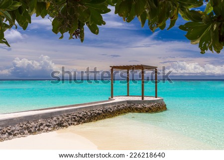 Wooden pavilion with footbridge at Maldives in front of Indian ocean
