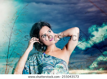 Double exposure of beautiful young woman on a background of sky and clouds expressing purity and freedom. Fashion