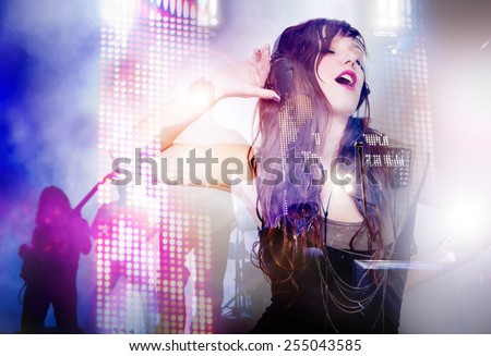 Beautiful woman listening music with live band background. Concept background of live music and party