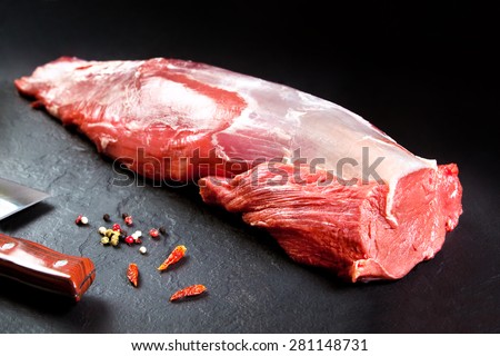 Fresh and raw meat. Whole piece of Sirloin steaks in a row ready to cook. Background black blackboard