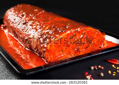 whole piece of marinated pork ready to cook
