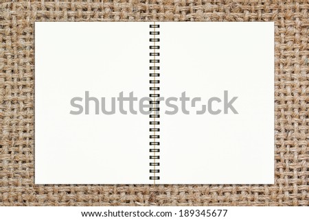 Blank realistic spiral notepad notebook on sack texture