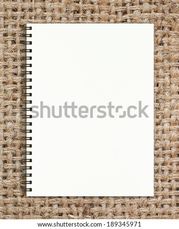 Blank realistic spiral notepad notebook on sack texture