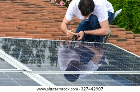 man on roof measuring for solar panel installation