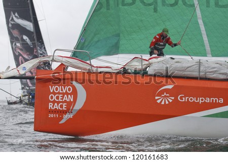 GALWAY, IRELAND - JULY 7: Unidentified foredeck crewman on bow of France\'s Groupama during In-port race of 2011-2012 Volvo Ocean Race in Galway, Ireland on July 7, 2012.