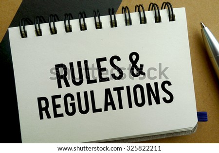 Rules and regulation memo written on a notebook with pen