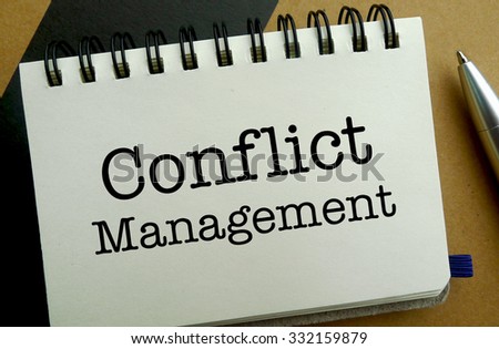 Conflict management memo written on a notebook with pen