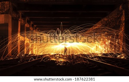 Man Spinning the Burning Steel Wool At Night