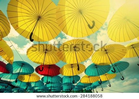 colorful yellow, red and blue  umbrellas under the beautiful cloude sky, natural background