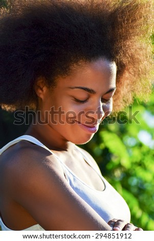 laughing young happy and  pretty afro woman on natural background