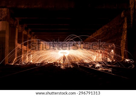 Man Spinning the Burning Steel Wool in old building At Night