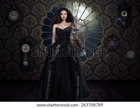 Fantasy woman in victorian black dress holding cage with owl. Vintage room with clocks and large window. Book cover
