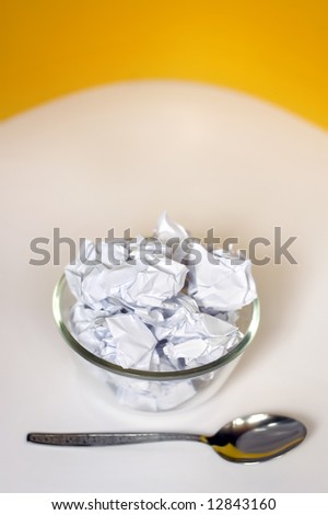 Junk food concept with creased paper in a bowl Focus on the paper