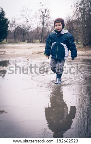 child running in a dirty pool of water