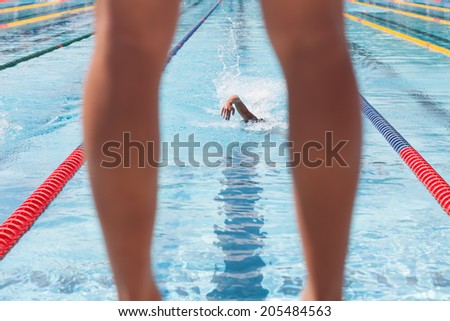 photo of swimmer waiting for his team member during a relay race contest