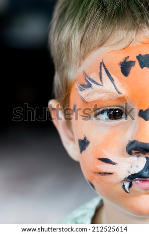boy with painted face as a tiger
