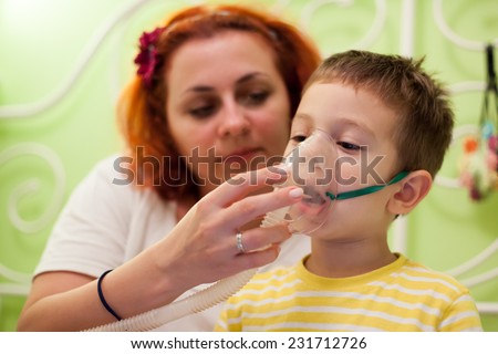 photo of caring mother and kid curing illness with aerosols inhalation