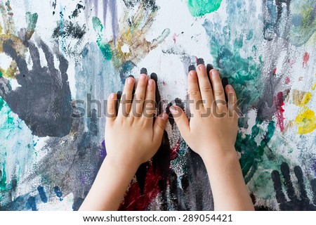 colourful wall painted with finger prints by children in kindergarten