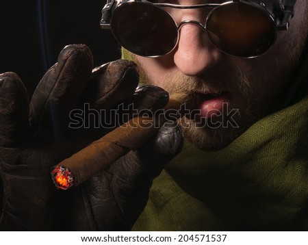 man in a green scarf with a cigar in his hand