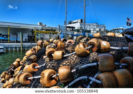 Pile of commercial fishing nets with floats in front of a Florida seafood processing plant