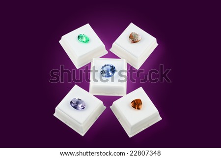 Various colors of faceted gem stones, in white boxes, with clipping path.