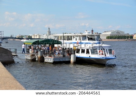 SAINT-PETERSBURG, RUSSIA, JULY 20, 2014: Tourists get on a ship, St. Petersburg, Russia