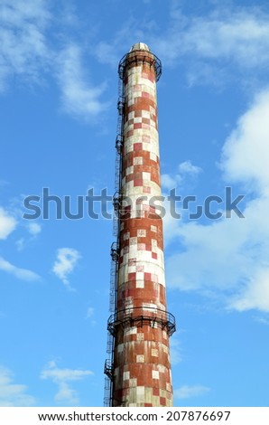 An old factory chimney on  blue sky background