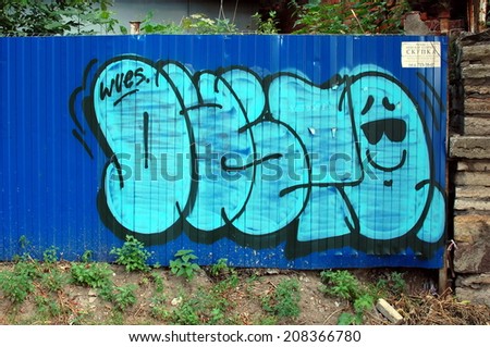 SAINT-PETERSBURG, RUSSIA, JULY 31, 2014: Graffiti tagging on a blue wall in Saint-Petersburg, Russia