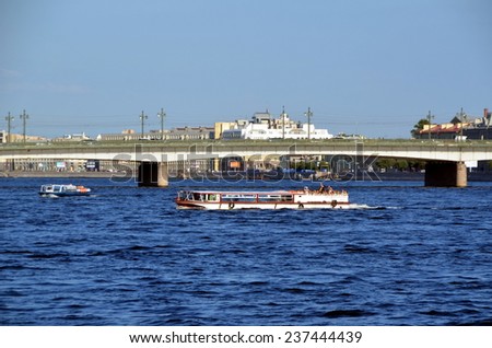 SAINT-PETERSBURG, RUSSIA, JULY 17, 2014: Excursion boats on the Neva river, St. Petersburg, Russia