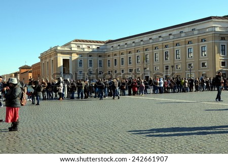 VATICAN CITY, VATICAN - DEC 29, 2014 - Tourists in long line at Saint Peter\'s Square in Vatican City, Vatican. Saint Peter\'s Square is among most popular pilgrimage sites for Roman Catholics