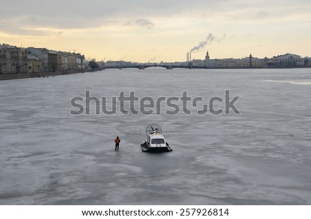 SAINT-PETERSBURG, RUSSIA, MARCH 1, 2015 - Emergency worker stands next to hydroplane on the Neva river. Action in memory of Boris Nemtsov on March 1, 2015