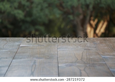 Empty wood table with forest background