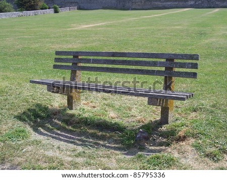 Photo of a bench in front of grass area
