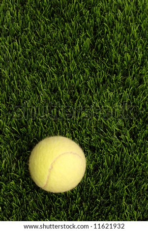 yellow tennis ball on the man-made lawn