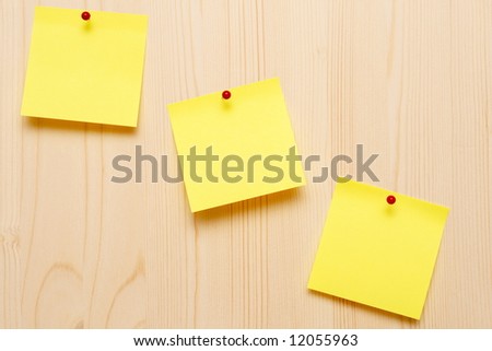 yellow sticky notes on wooden background