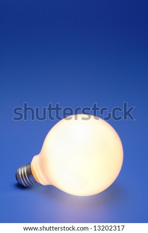 A lit up light bulb on a blue background.