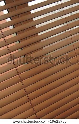 wooden venetian blind, jalousie or shutter half closed