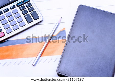 growing financial diagram and calculator on table
