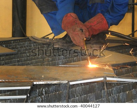 metal worker welding metal beam